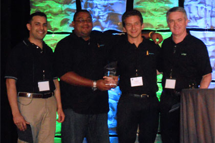Renato Lezama, Beacon, VP Regional Operations (2nd left) and Christopher Woodhams, Beacon, COO (2nd right), accepting the Customer of the year Award at the 2012 International LANSA User Conference.