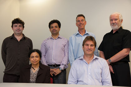 IT Manager Ms Mitra Bhar (sitting on the left) with the OBOS Applications Development team, standing from left to right Jim Watterson, Vince Lazzaro, Brett Ecclestone, Michael Major and sitting Muir Mathieson.